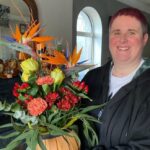 Aisling holding a bouquet of flowers and smiling on her birthday